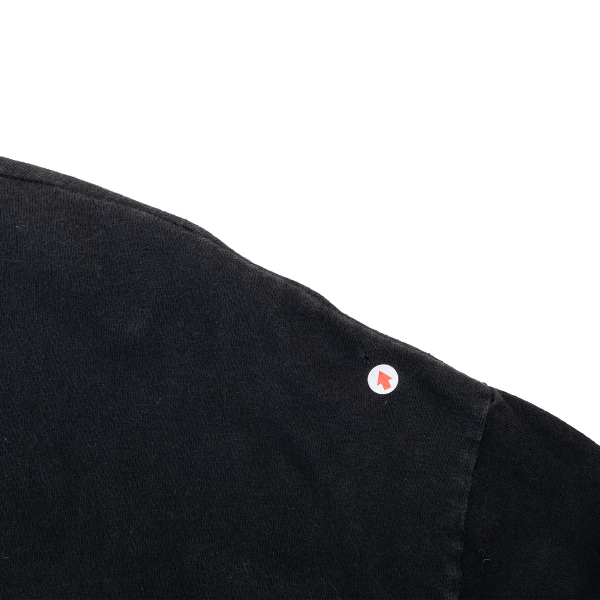 Close-up of the black T-shirt sleeve seam