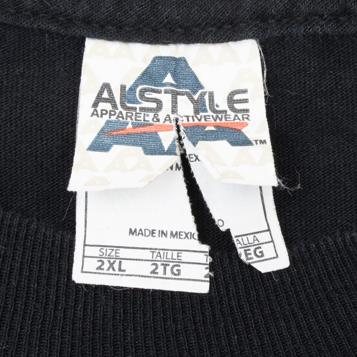 Close-up of torn Alstyle neck tag marked size 2XL and made in Mexico