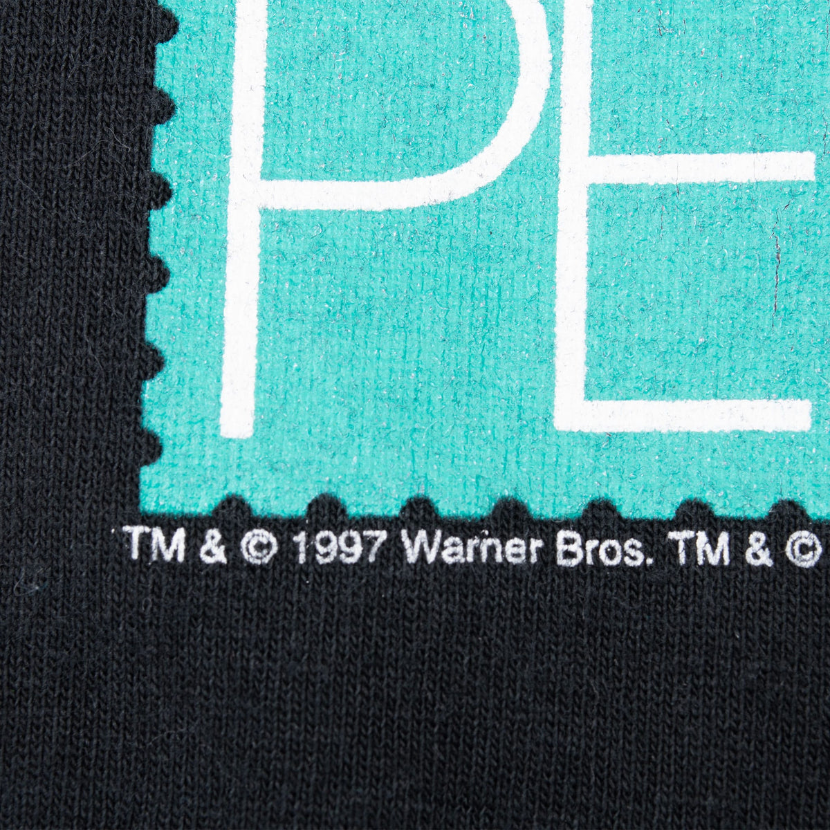 Close-up of Stampers print edge and 1997 Warner Bros. copyright text