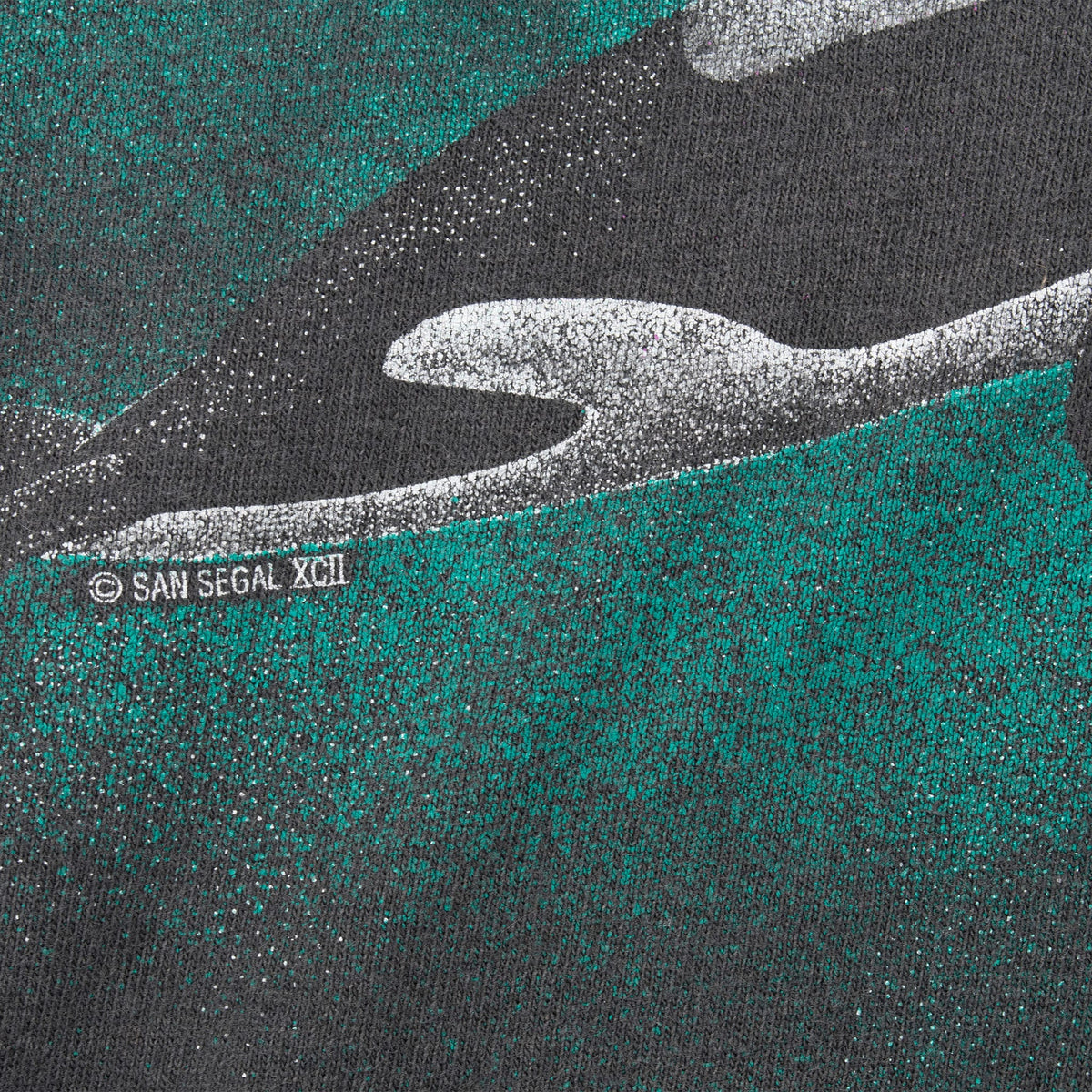 Orca print detail showing San Segal copyright mark and teal background