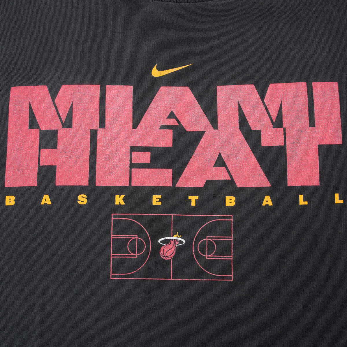 Close-up of red Miami Heat graphic with yellow Nike Swoosh and basketball court design