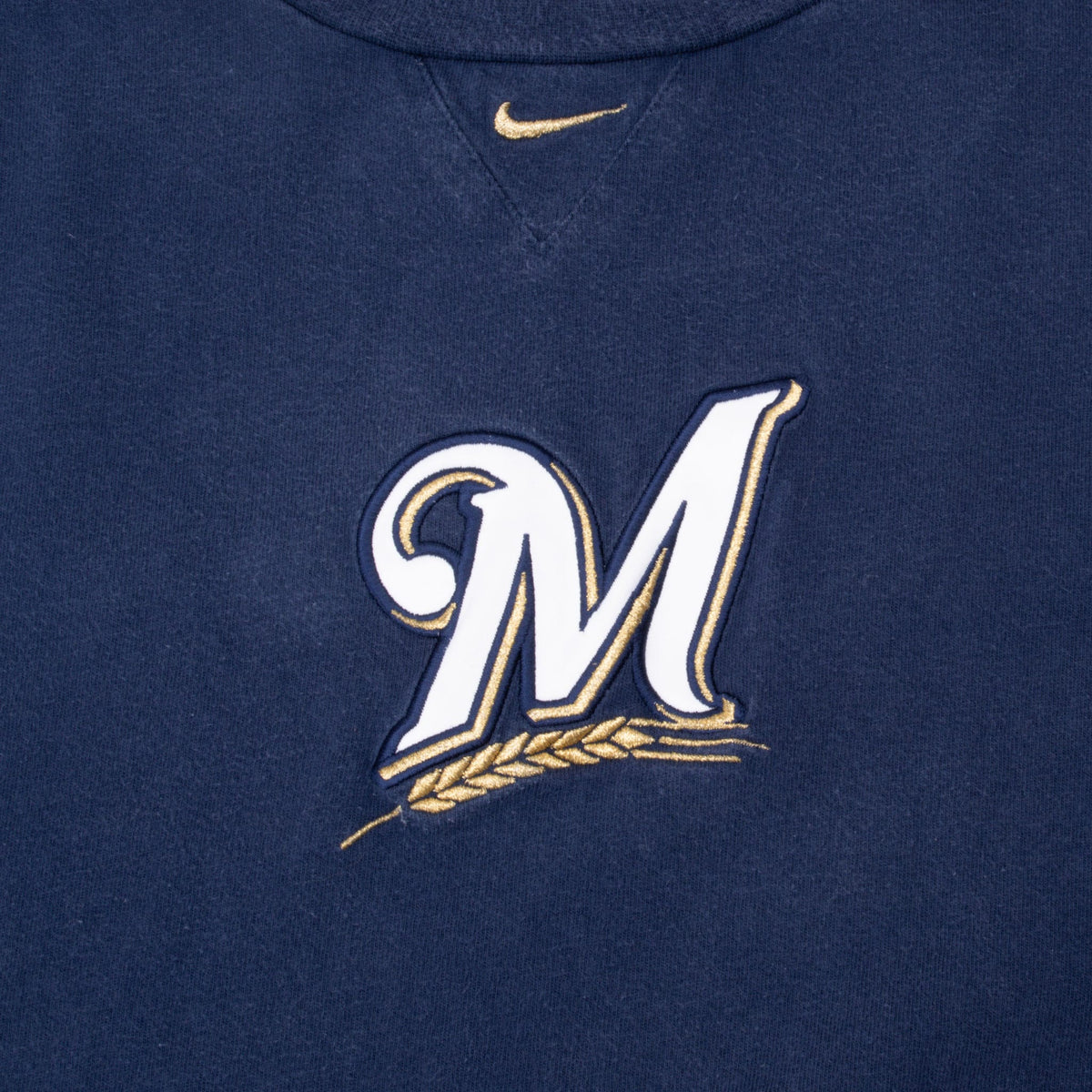 Milwaukee Brewers white and gold M chest logo with gold Nike Swoosh above