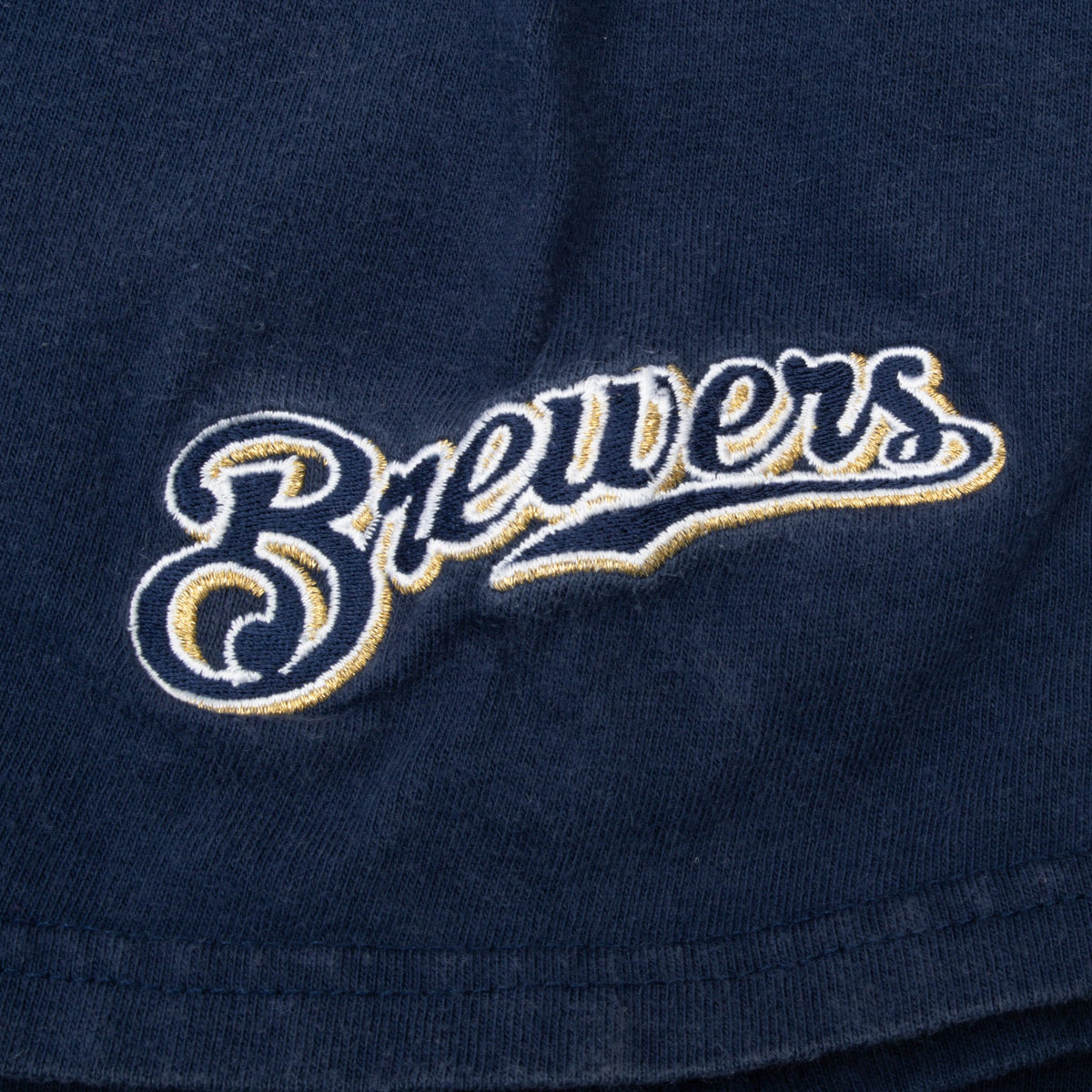 Brewers script embroidery in white and gold on blue T-shirt sleeve