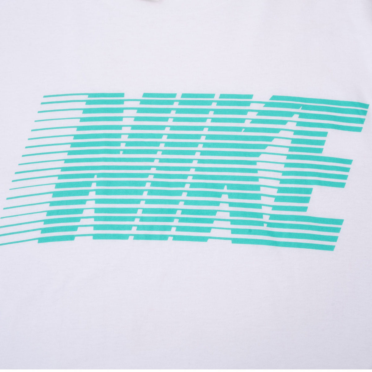 Close-up of turquoise striped Nike wordmark printed on white fabric