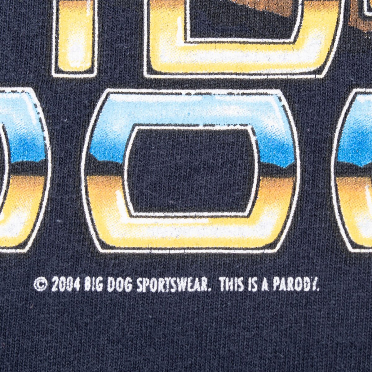Close-up of back print copyright text reading 2004 Big Dog Sportswear, This Is a Parody