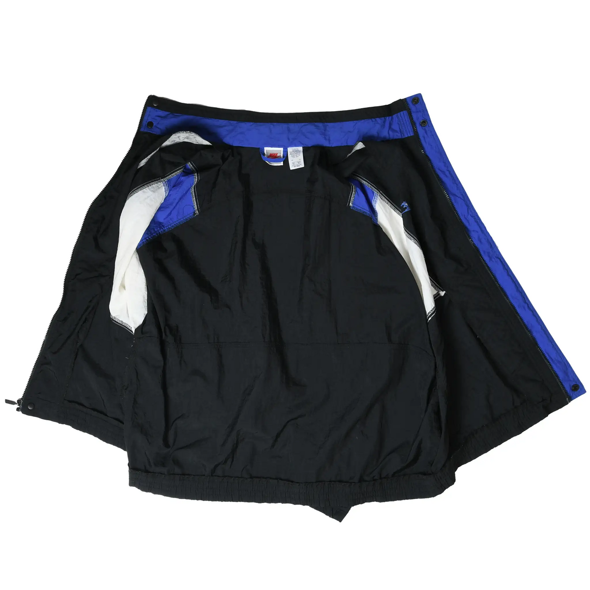 Open Nike windbreaker showing black interior lining, white pocket lining, and blue trim