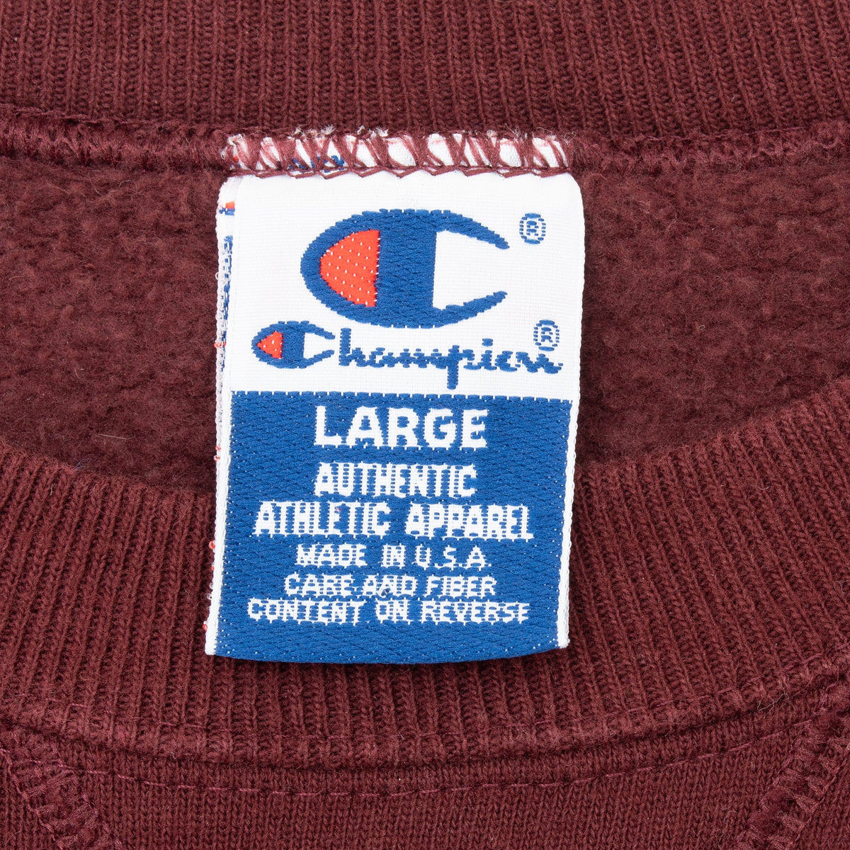 Champion neck label showing size Large, Made in USA, and care instructions