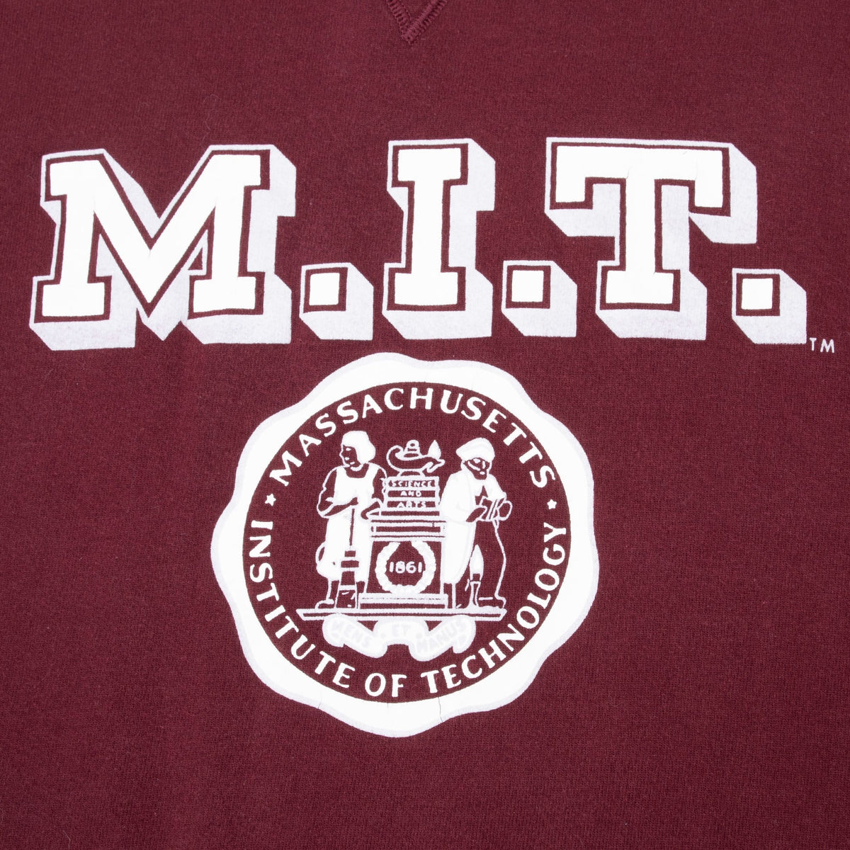 Close-up of white M.I.T. lettering and Massachusetts Institute of Technology crest print
