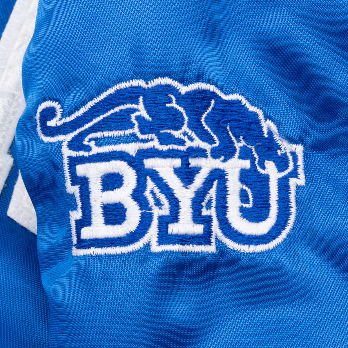 Close-up of embroidered BYU Cougars sleeve emblem in blue and white