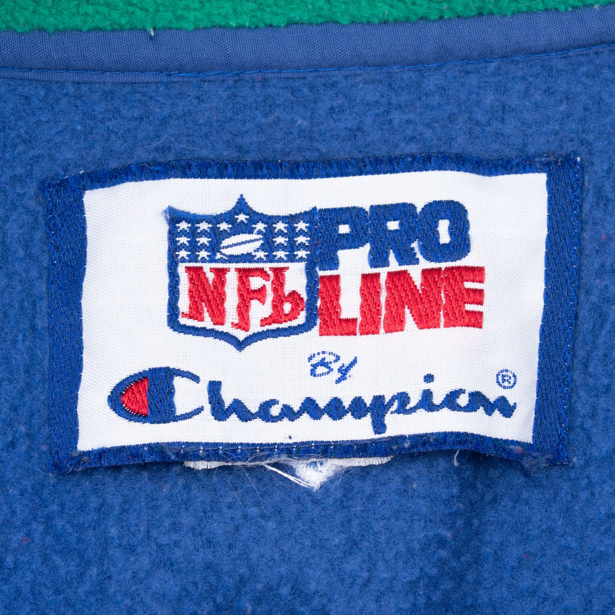 Close-up of NFL Pro Line by Champion neck label inside the blue fleece