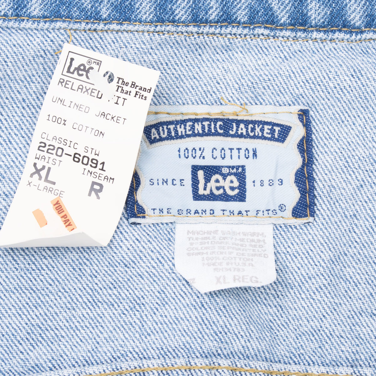 Lee jacket neck labels and paper tag showing XL regular sizing and 100% cotton
