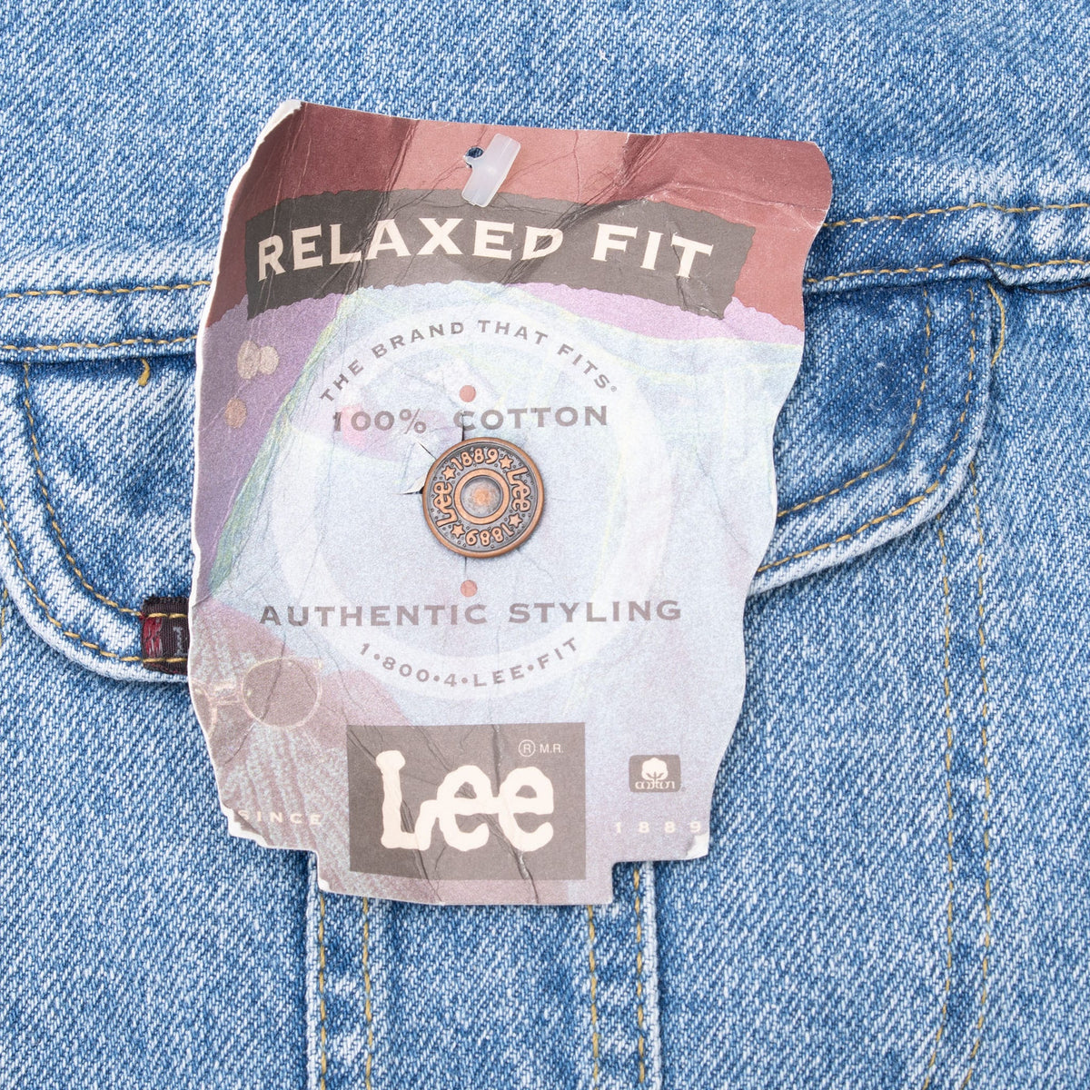Lee relaxed-fit paper hangtag attached to blue denim chest pocket