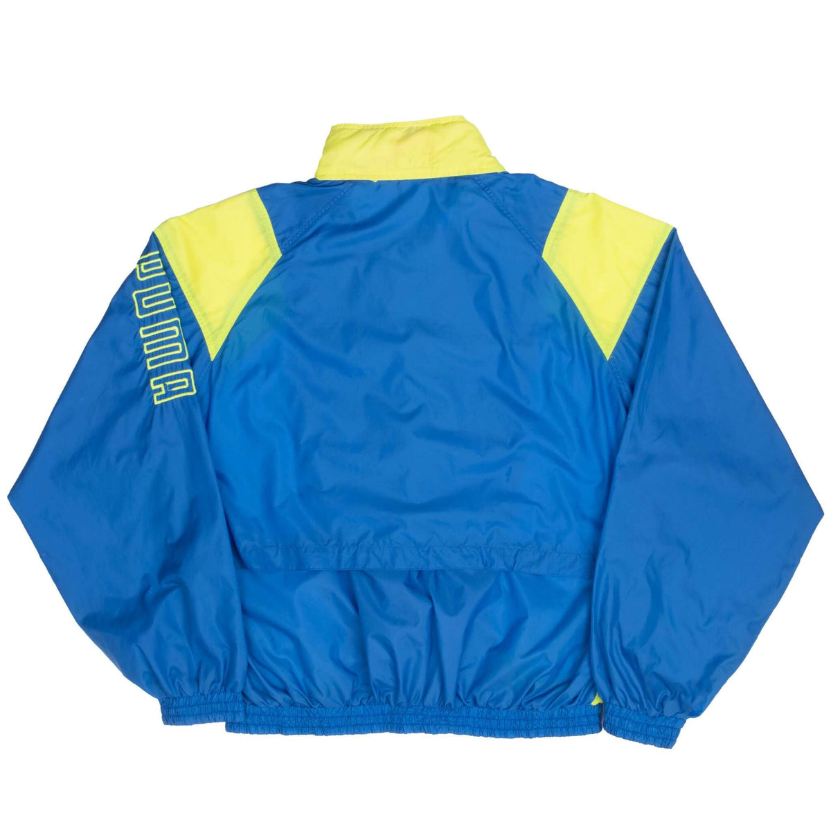 Back of blue Puma windbreaker with neon yellow shoulder panels and sleeve logo