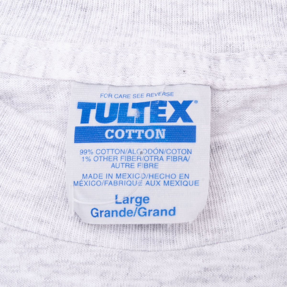 Close-up of Tultex Cotton neck label marked Large on gray T-shirt