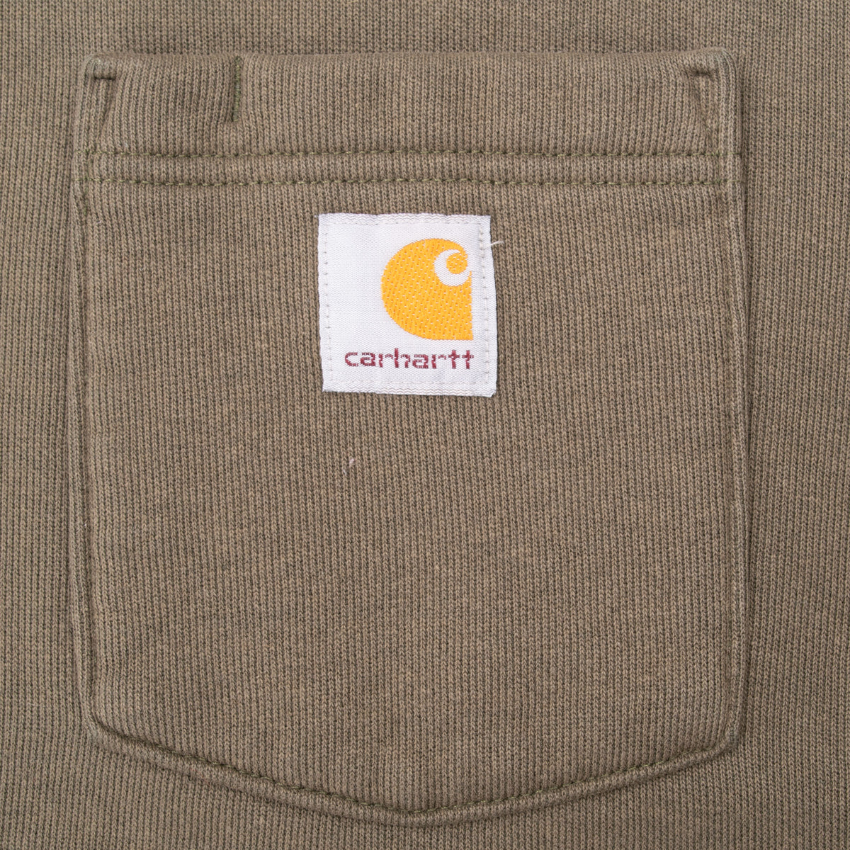 Close-up of chest pocket with Carhartt logo patch