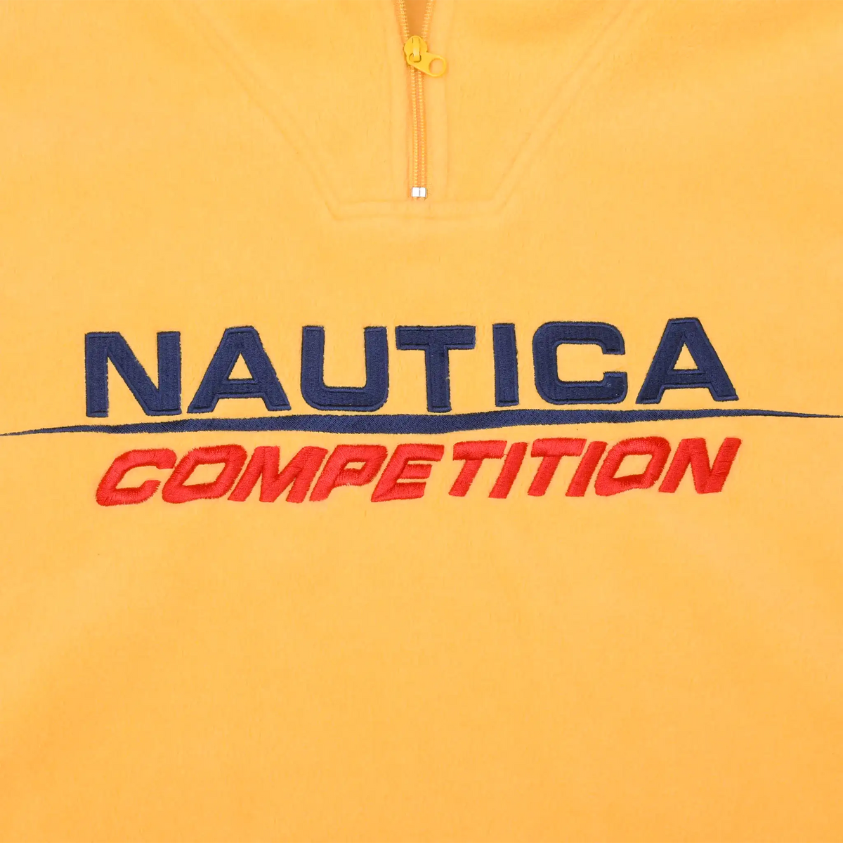 Close-up of navy and red Nautica Competition chest embroidery below quarter zip