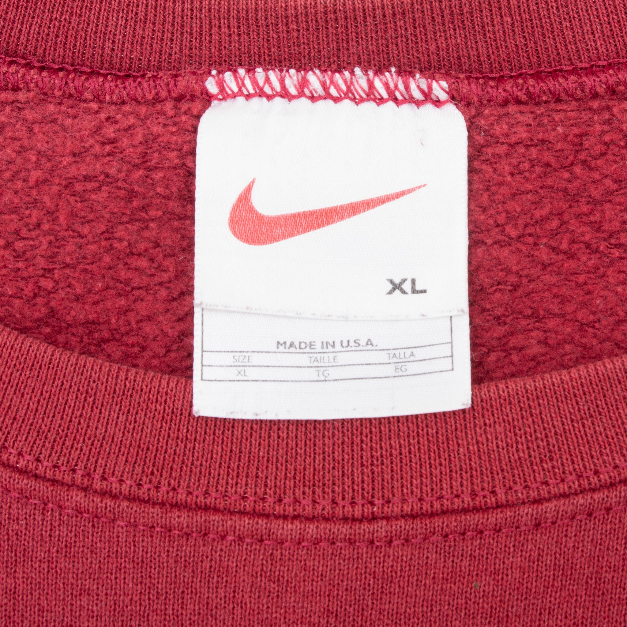 Nike neck tag showing swoosh logo, XL size, and Made in U.S.A. text