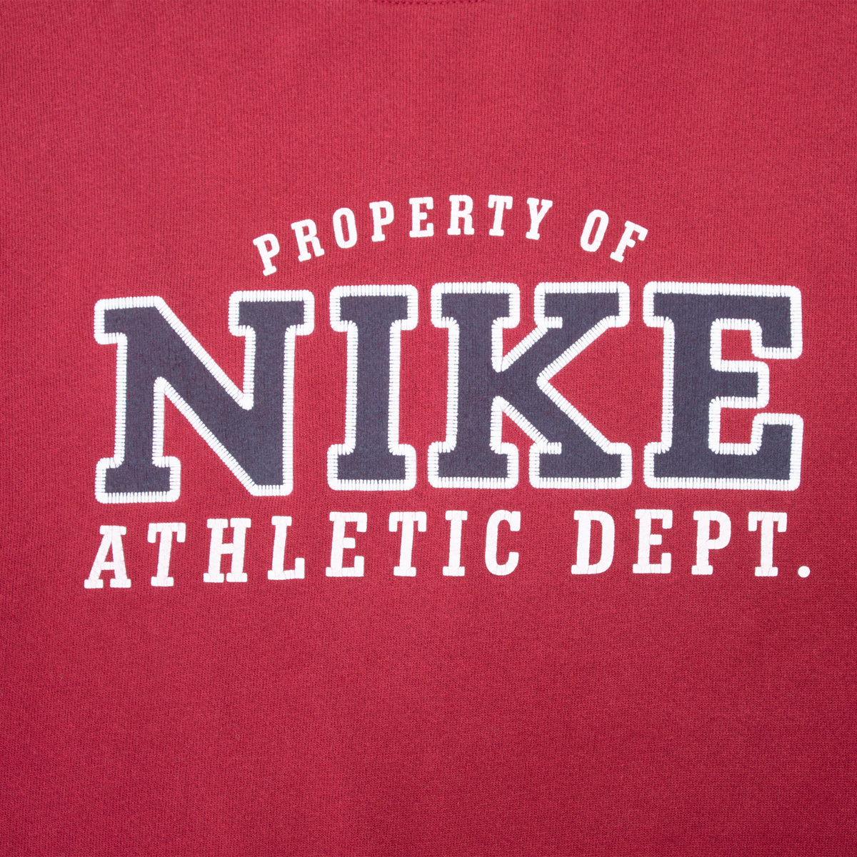 Close-up of Property of Nike Athletic Dept. chest graphic on burgundy sweatshirt