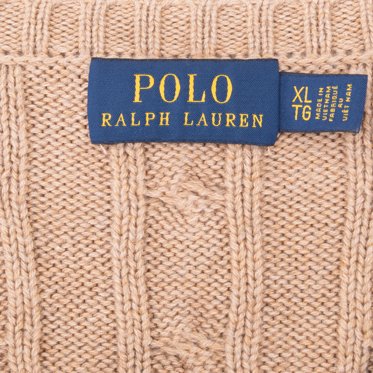 Polo Ralph Lauren neck label and XL size tag on light brown knit sweater