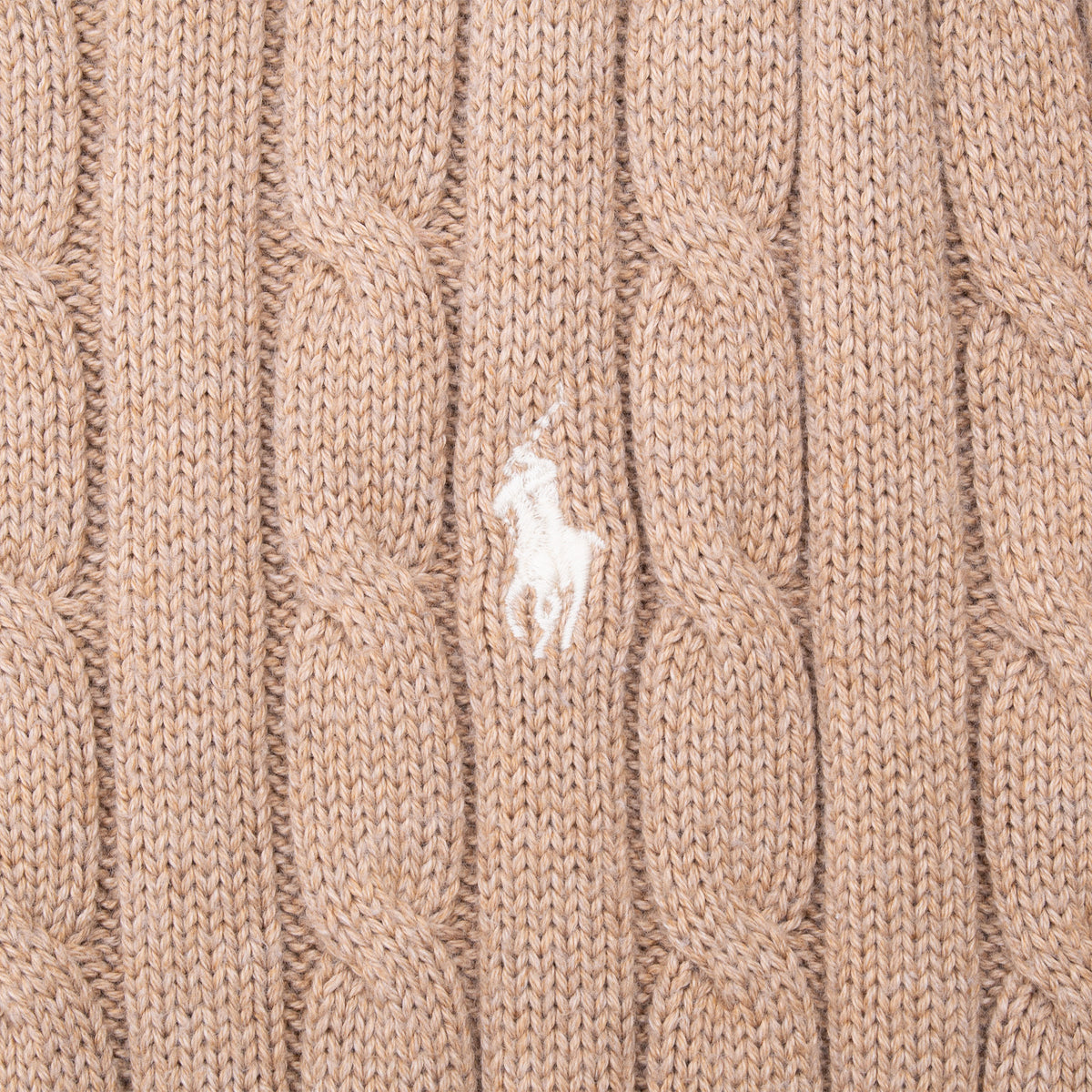 White Polo pony embroidery detail on light brown cable-knit sweater