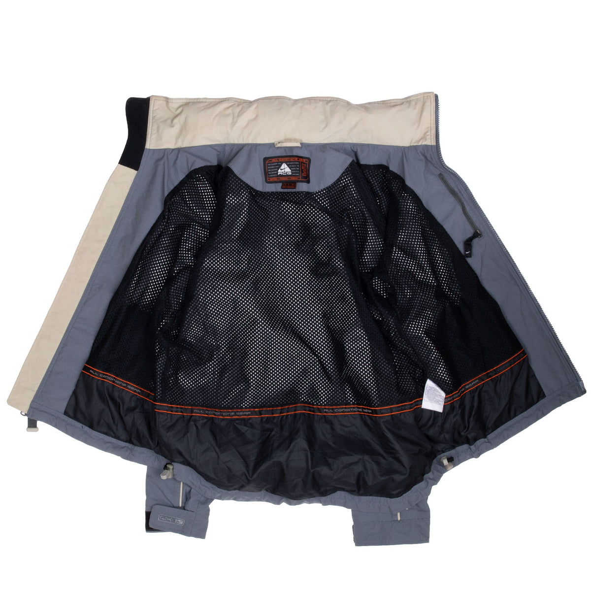 Open Nike ACG windbreaker showing black mesh lining, interior pocket and collar label
