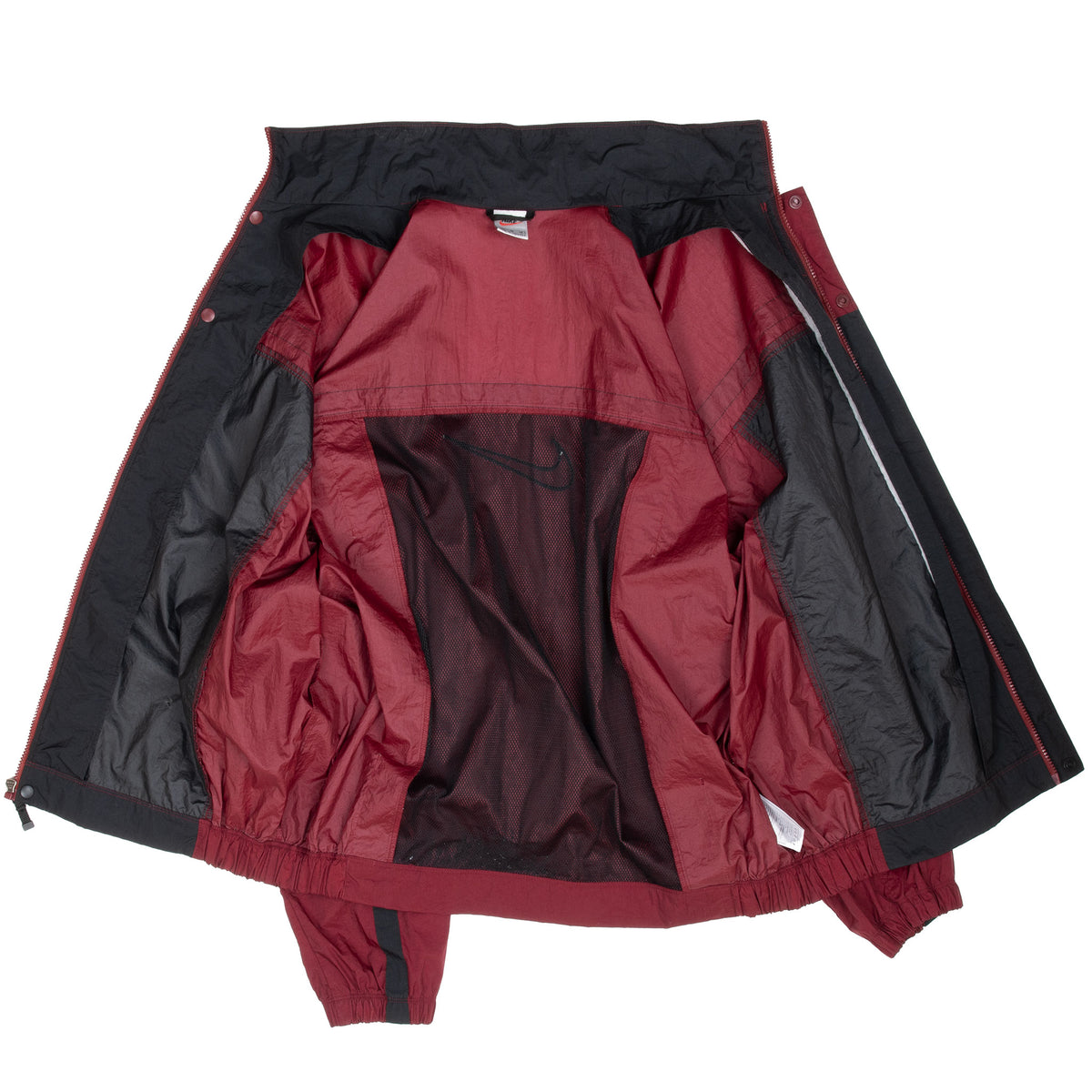 Open Nike windbreaker showing burgundy and black mesh-lined interior