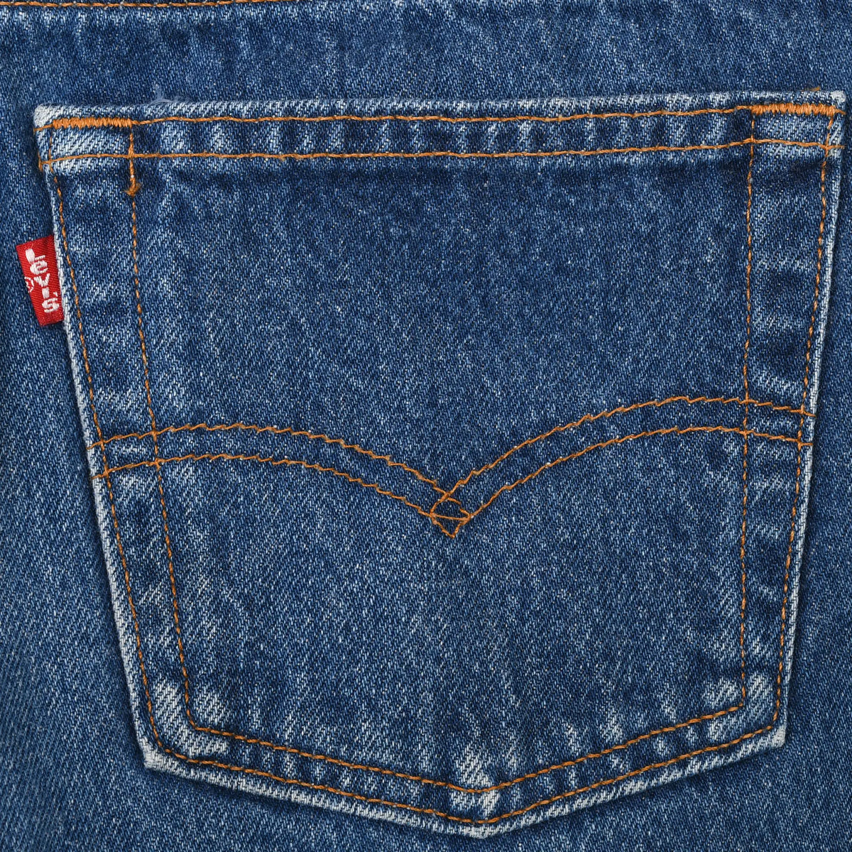 Levi's blue jeans back pocket with orange arcuate stitching and red tab