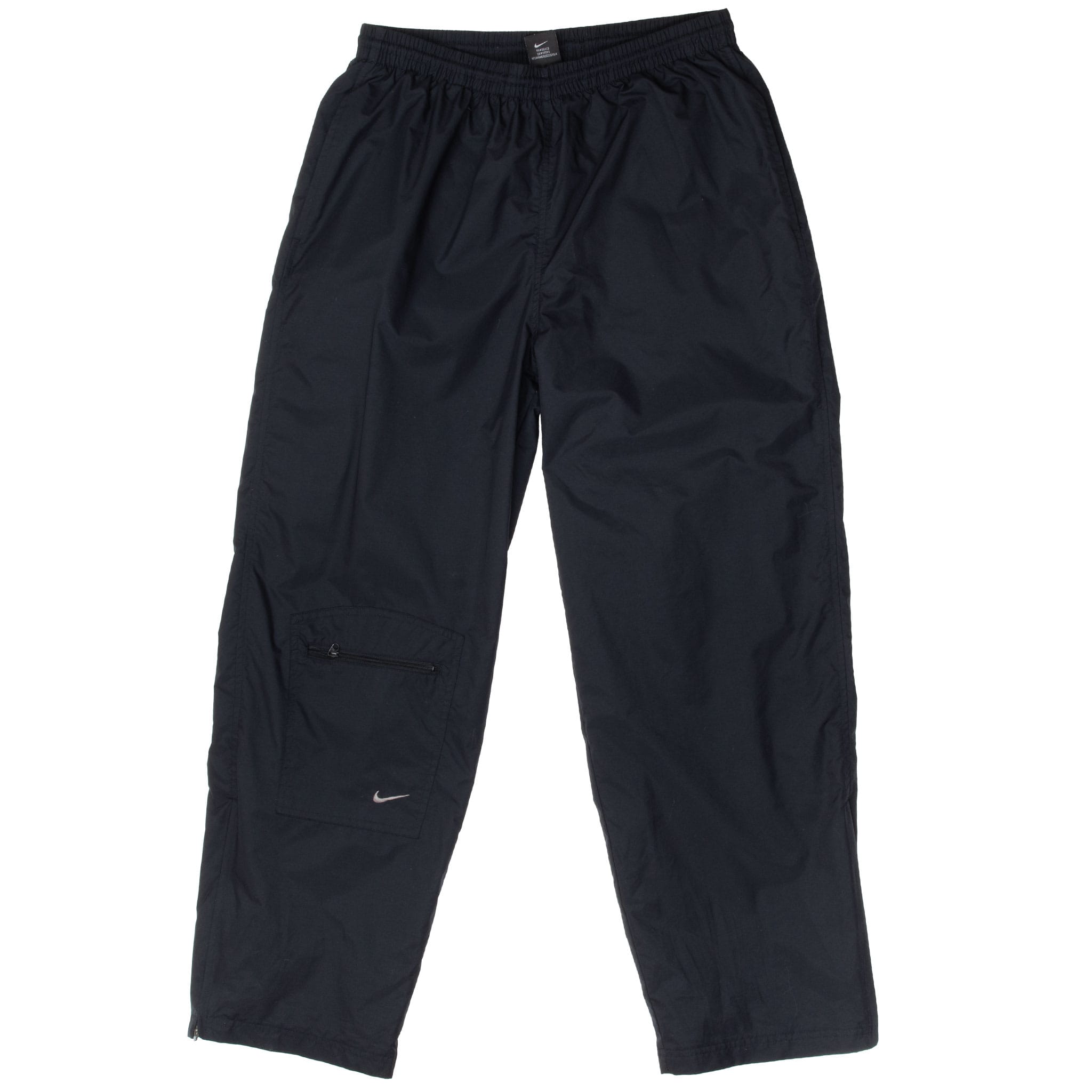 Front of black Nike track pants with lower-leg zip pocket and silver embroidered Swoosh