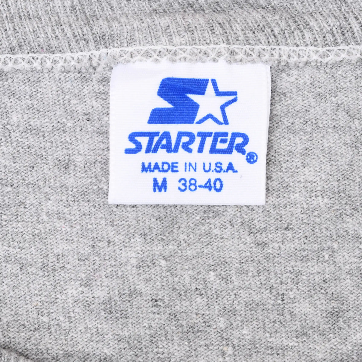 Close-up of blue Starter neck label marked Made in U.S.A. and M 38-40