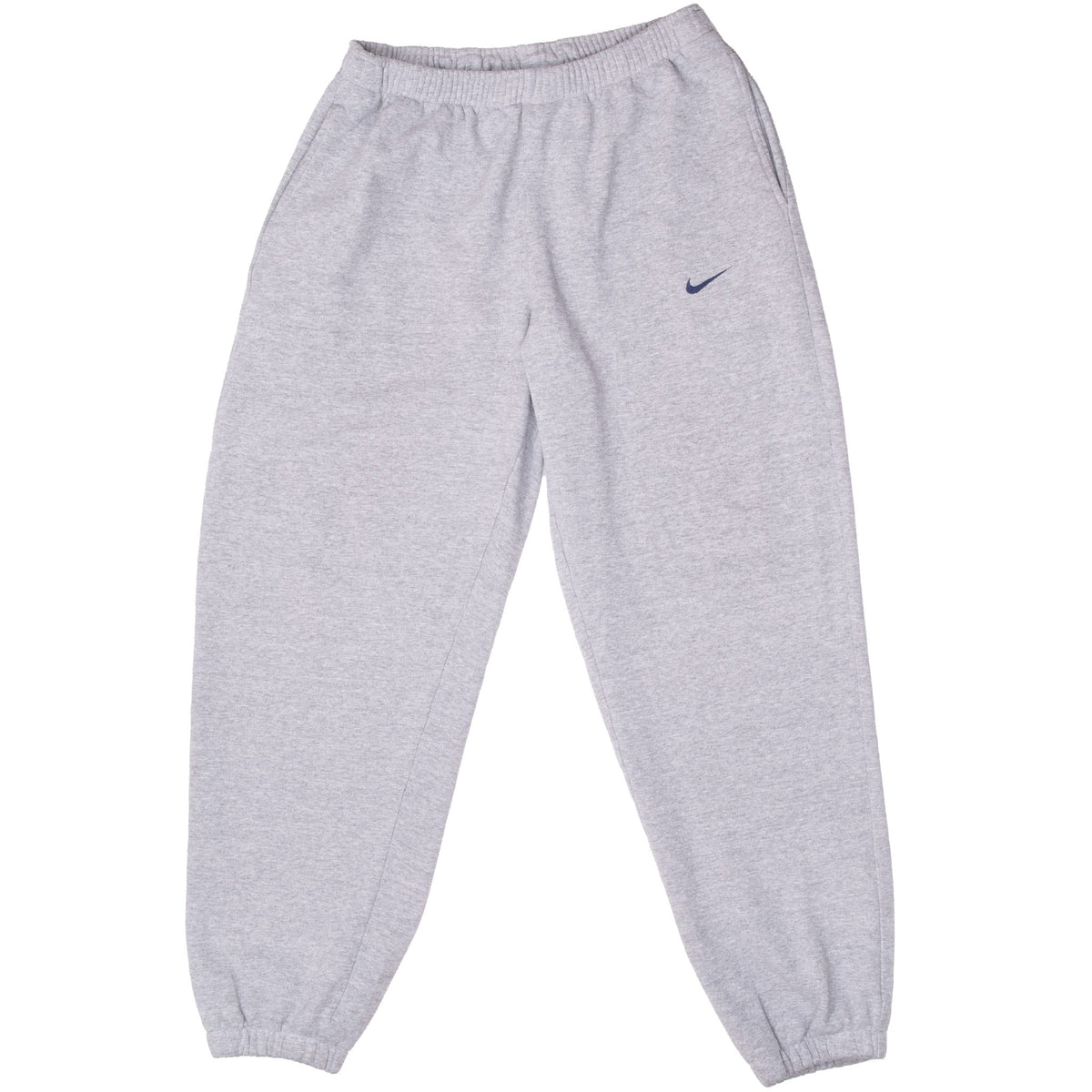 Front of grey Nike sweatpants with dark blue embroidered Swoosh and elastic cuffs