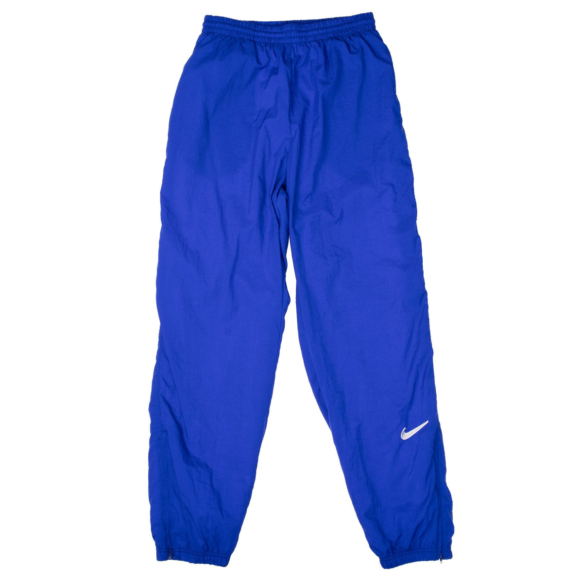 Front of blue-purple Nike women's track pants with white Swoosh and elastic cuffs