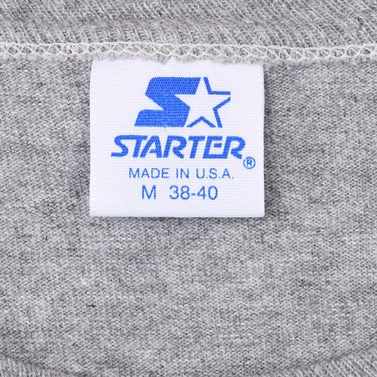 Starter neck label reading Made in U.S.A. and M 38-40 on gray fabric