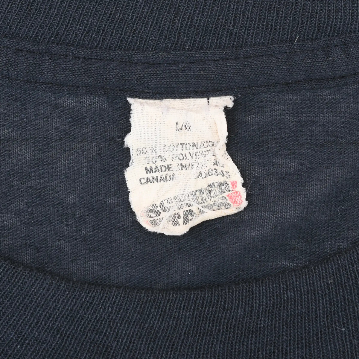 Close-up of worn neck tag inside black Rolling Stones T-shirt
