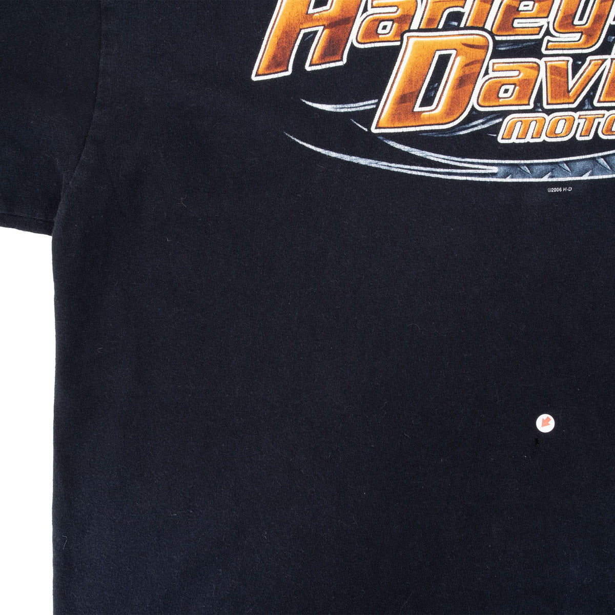 Close-up of black front fabric below the Harley-Davidson graphic with a small marked spot