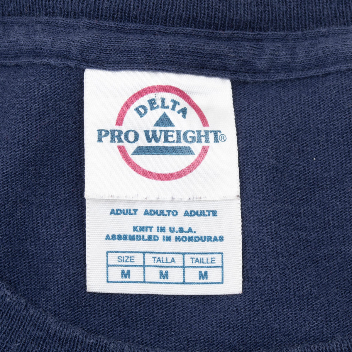 Close-up of Delta Pro Weight neck tag marked size medium