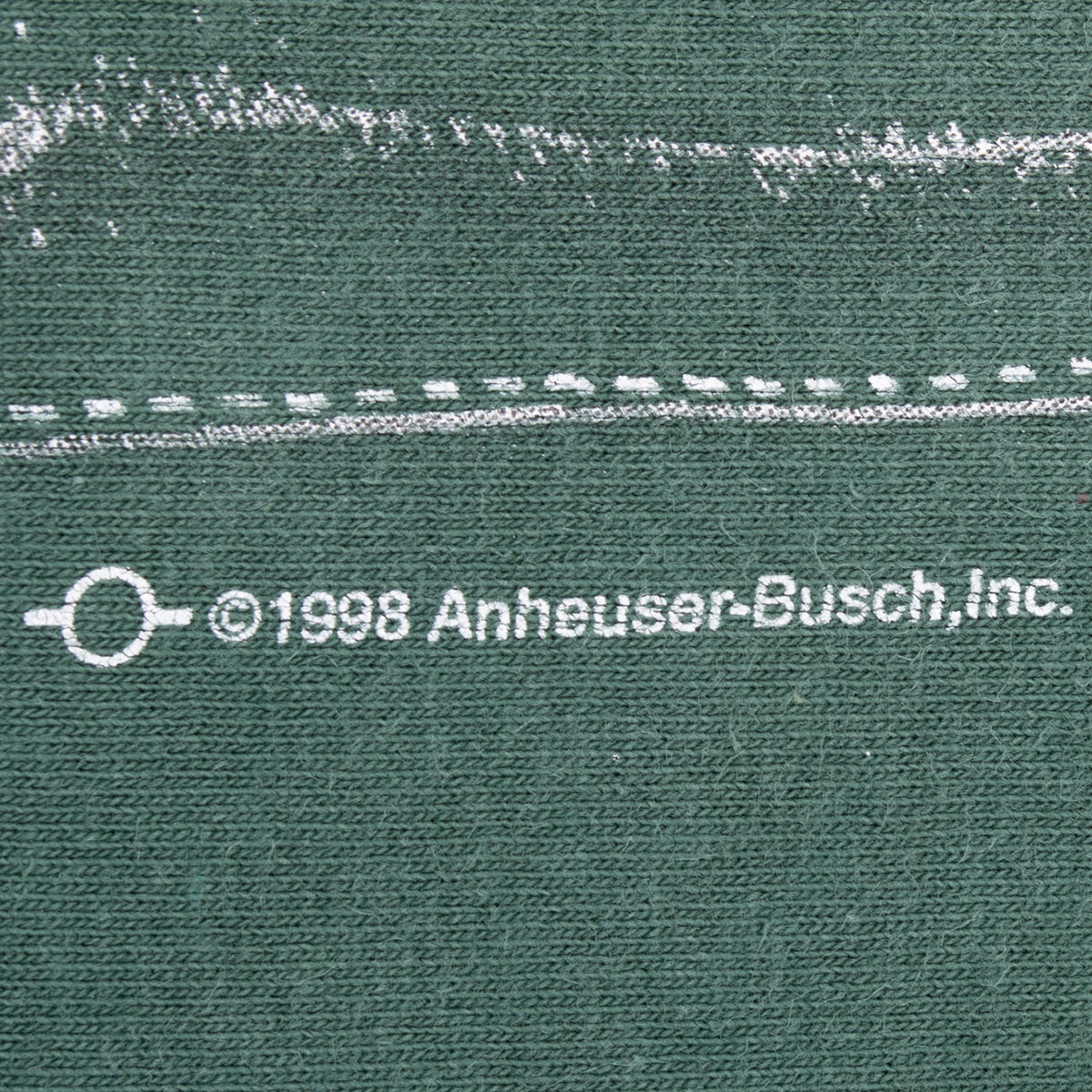 Close-up of 1998 Anheuser-Busch copyright print on green fabric