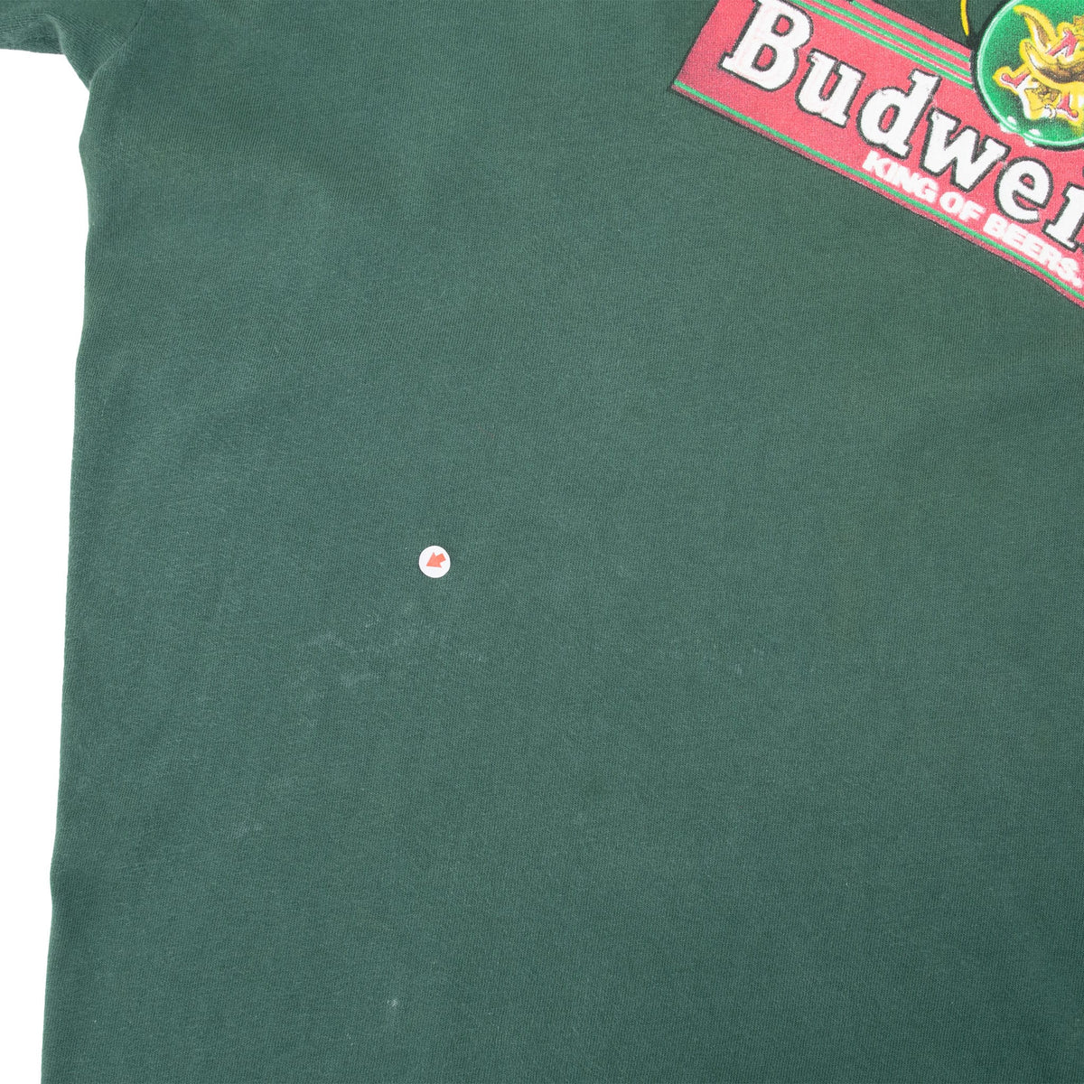 Close-up of small spot on the front green fabric below the Budweiser graphic