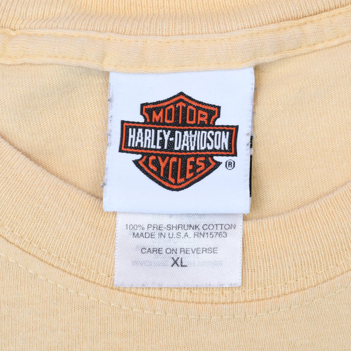 Harley-Davidson neck label and XL care tag inside tan T-shirt
