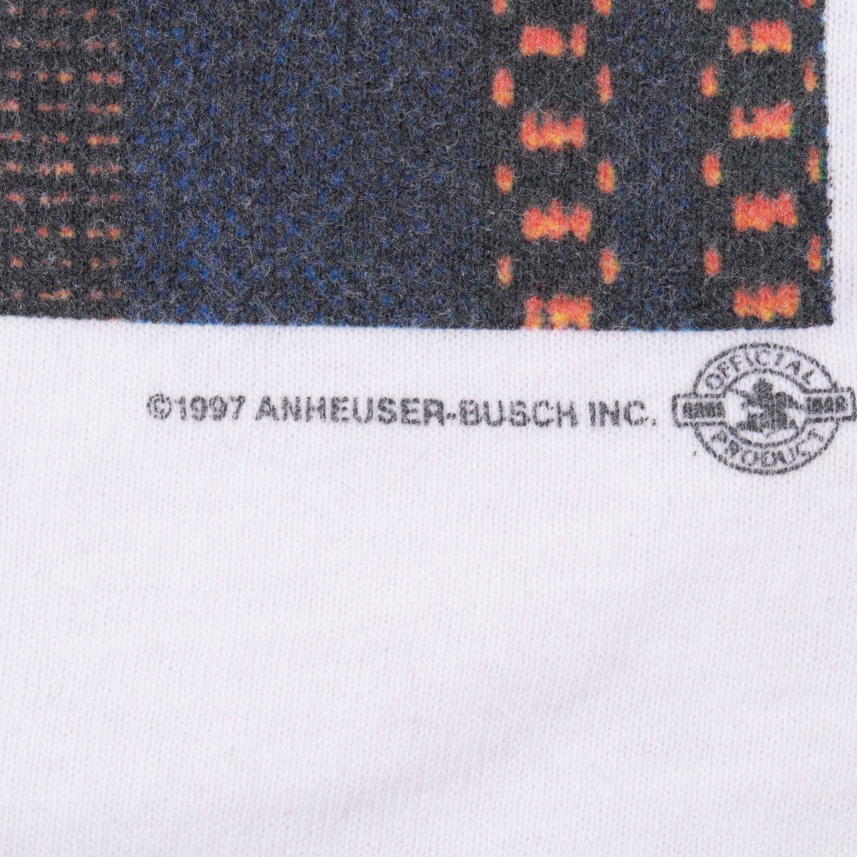 Close-up of 1997 Anheuser-Busch copyright text and licensed merchandise mark