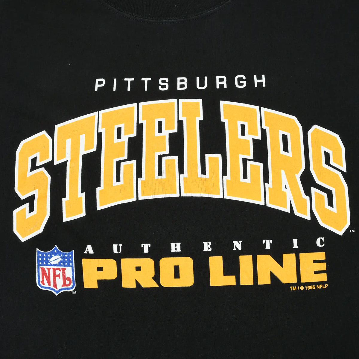 Close-up of gold and white Pittsburgh Steelers Authentic Pro Line chest graphic with NFL shield