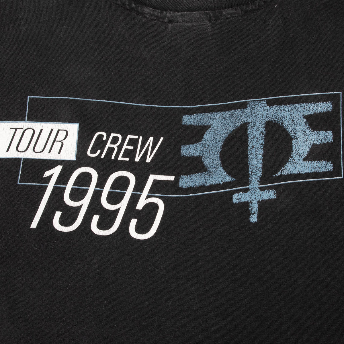 Close-up of blue-and-white Tour Crew 1995 back print and Melissa Etheridge symbol