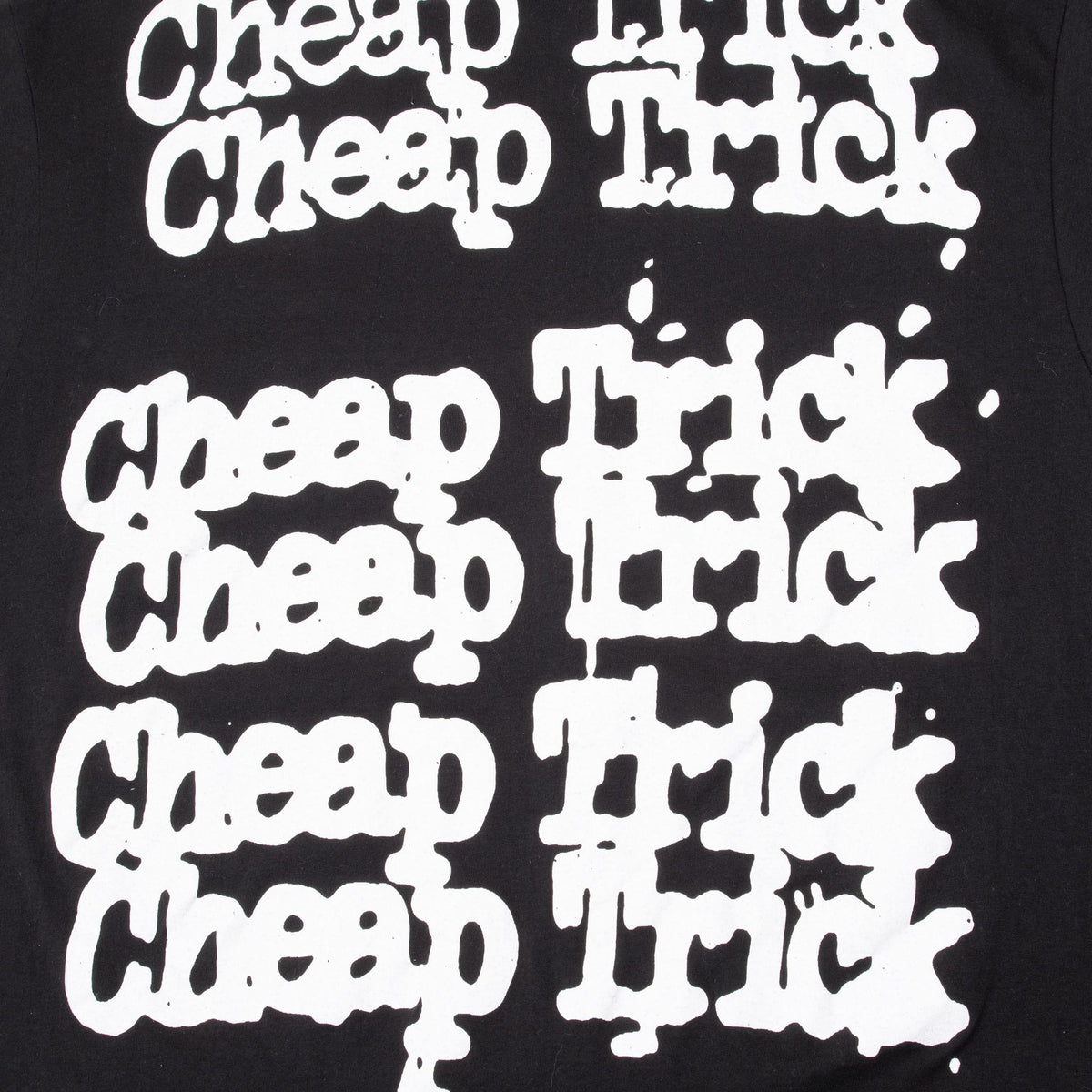 Close-up of repeating white Cheap Trick logo print on back of black T-shirt
