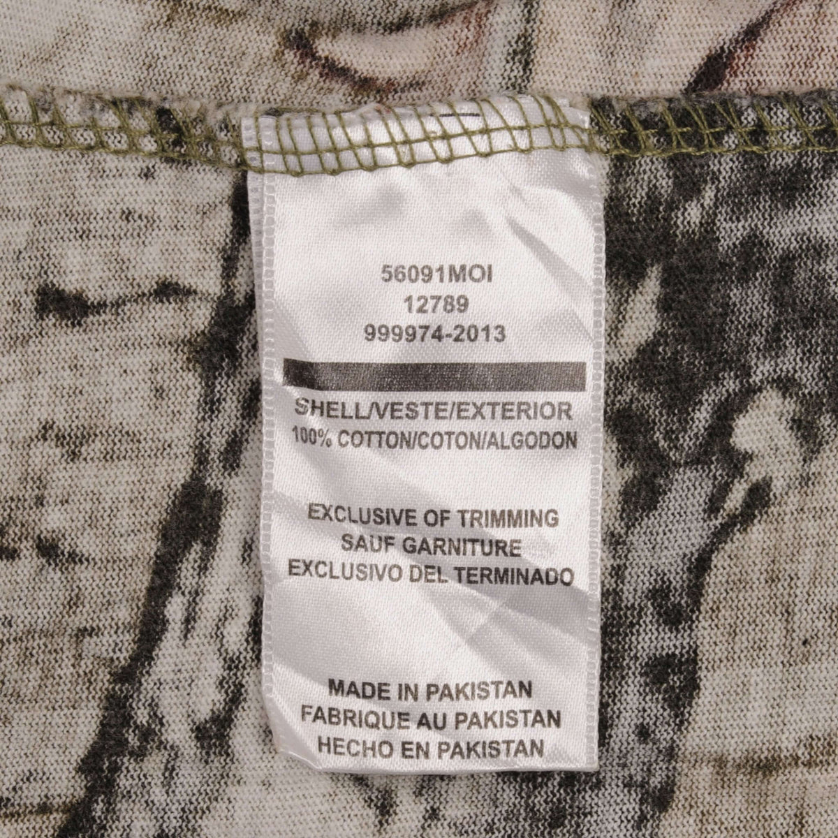 Interior care label showing 100% cotton and made in Pakistan