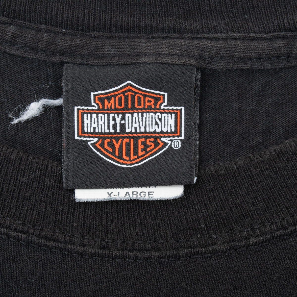 Harley-Davidson neck tag marked X-Large inside black T-shirt
