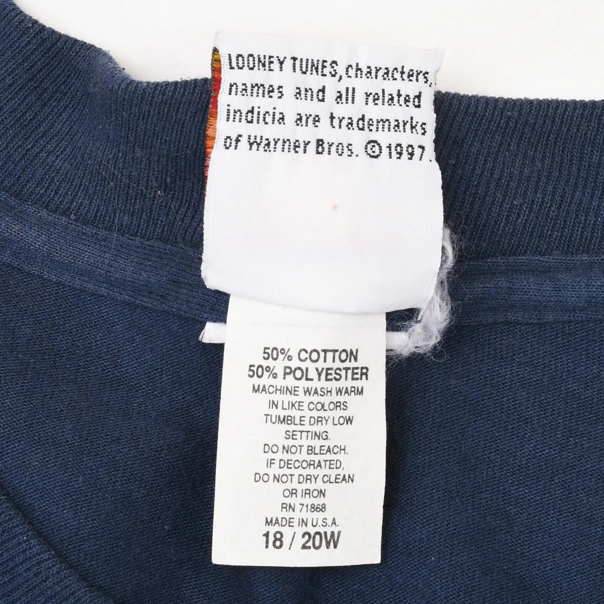 Reverse neck and care labels showing Warner Bros. copyright, fabric blend, size 18/20W, and USA manufacture