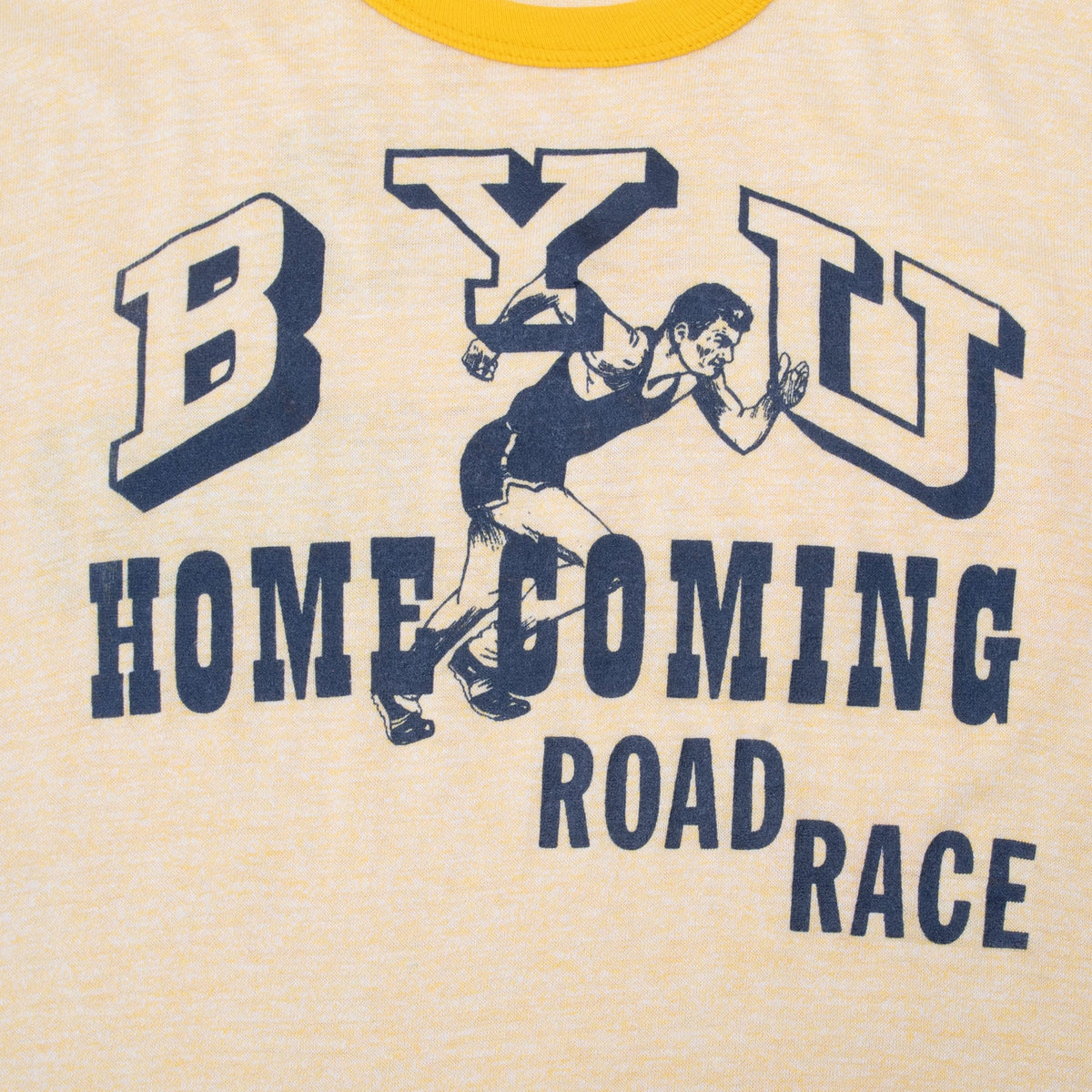 Close-up of navy BYU Homecoming Road Race front graphic with illustrated runners