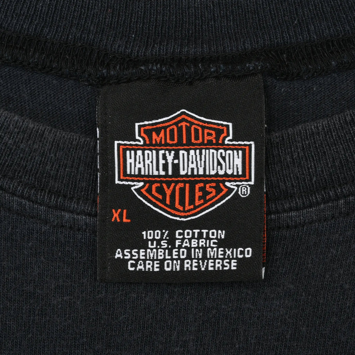 Harley-Davidson neck label showing XL, 100% cotton, and care information