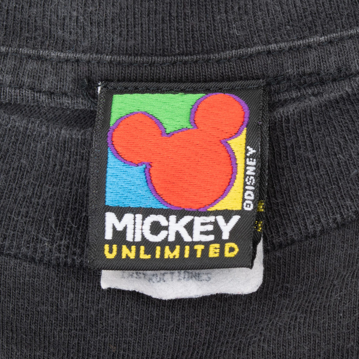 Mickey Unlimited neck label with colorful Mickey Mouse silhouette