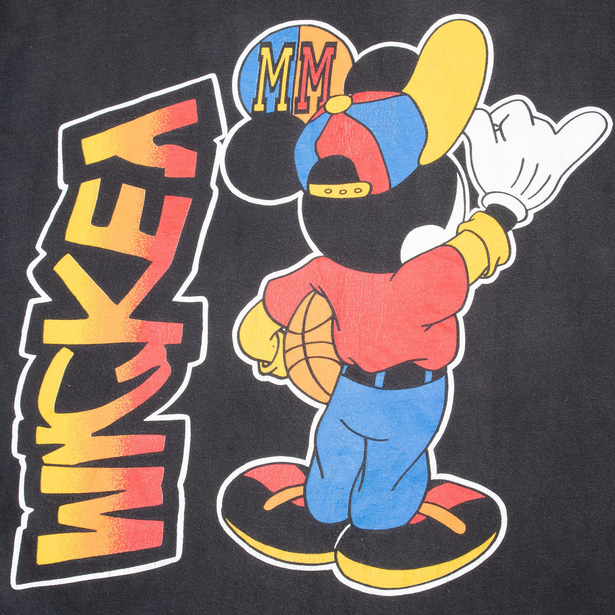 Close-up of back print showing Mickey Mouse holding a basketball beside vertical lettering