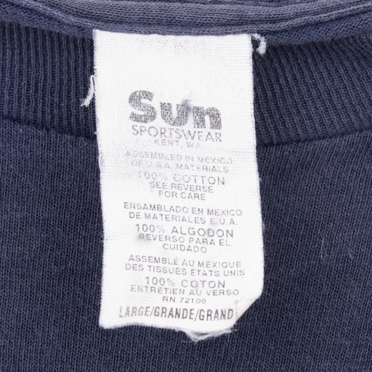 Sunn Sportswear neck tag showing 100% cotton and size large